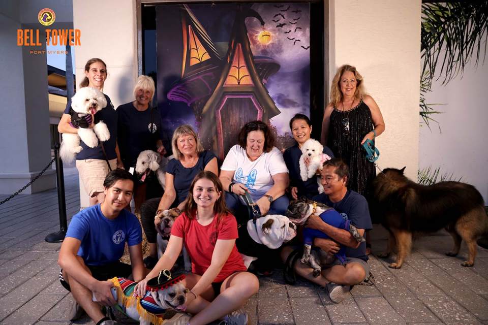 The Greater Fort Myers Dog Club posing with their dogs at Yappy Hour in Fort Myers